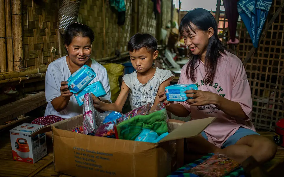 Unterstüztung von UNICEF für geflüchtete Familien | UNICEF/UNI871885/Htet Eine Familie packt hilfreiche Dinge für den Alltag aus